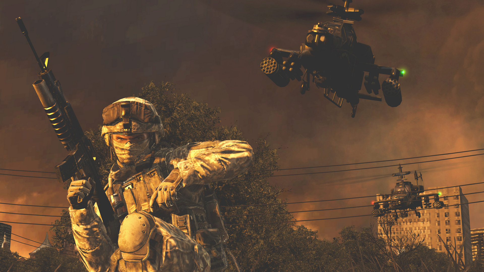 Soldat accroupi avec un fusil et hélicoptères dans un ciel orangé, dans Modern Warfare 2 (2009).