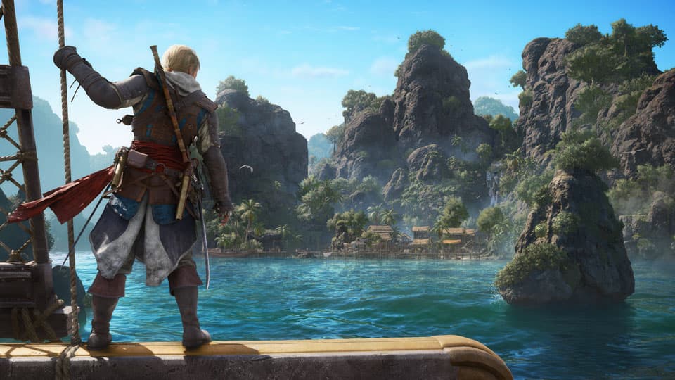 Edward Kenway observe une île tropicale depuis le Jackdaw dans une capture officielle de Black Flag Resynced.