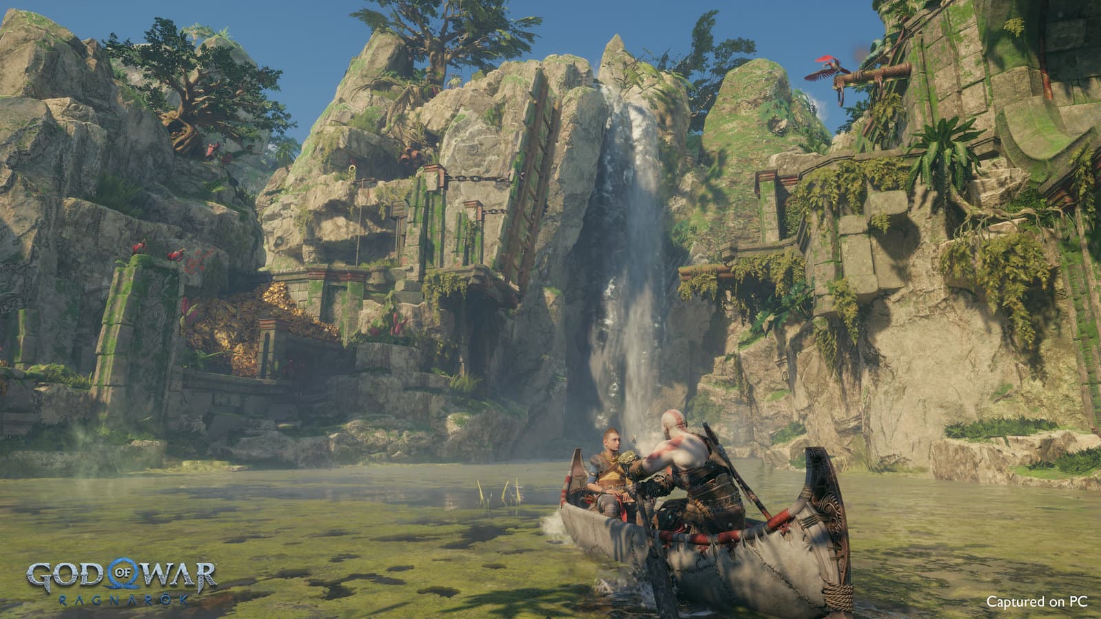 Kratos et Atreus naviguent vers une cascade dans une capture officielle de la version PC.