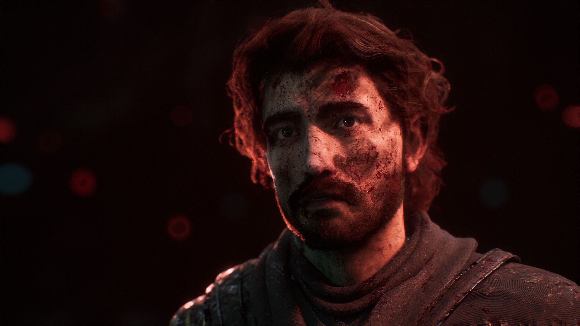 Portrait d’un homme éclairé par une lueur rouge.