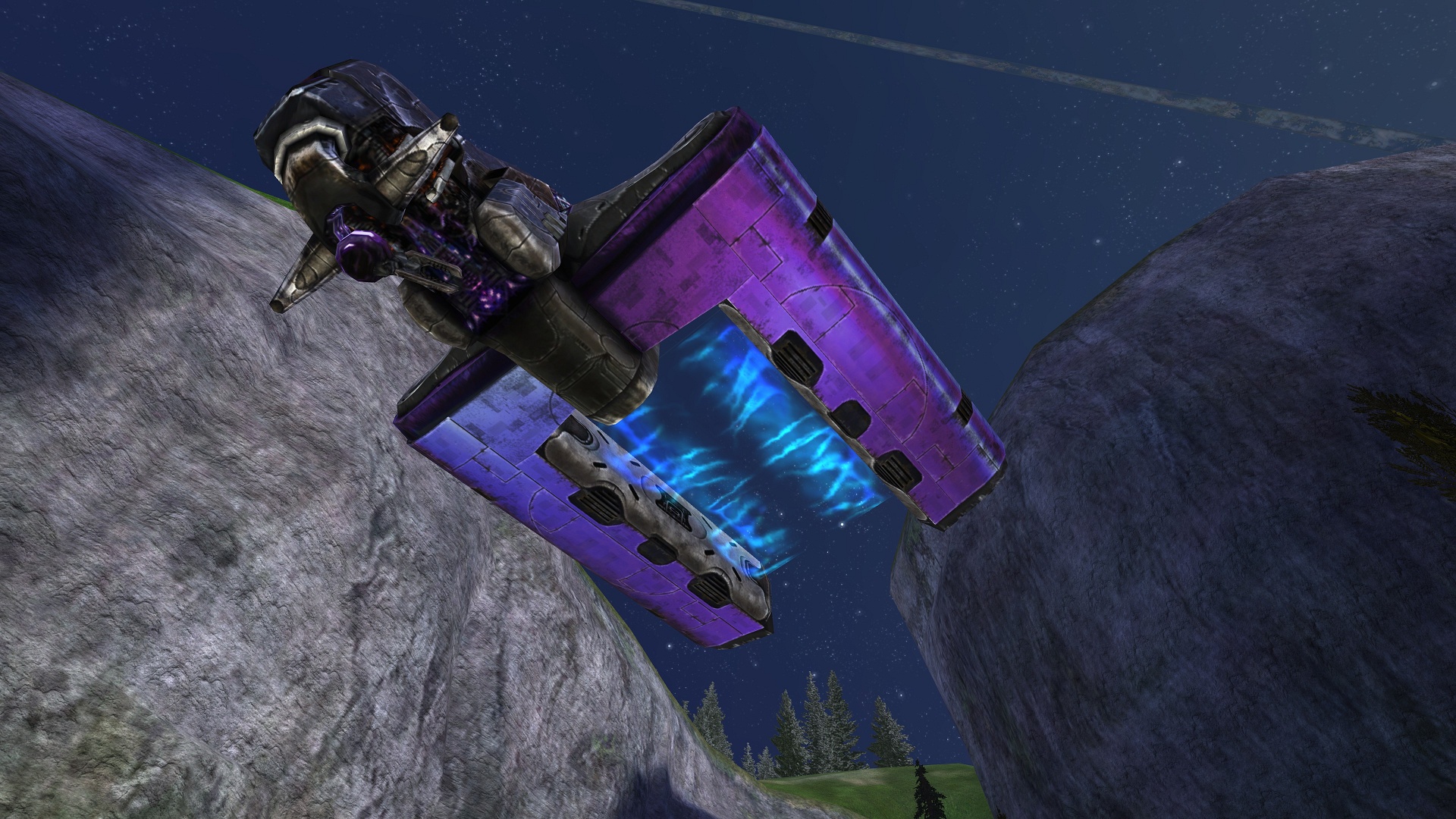 Un vaisseau de transport Spirit violet survole une vallée rocheuse, ses moteurs bleus allumés.