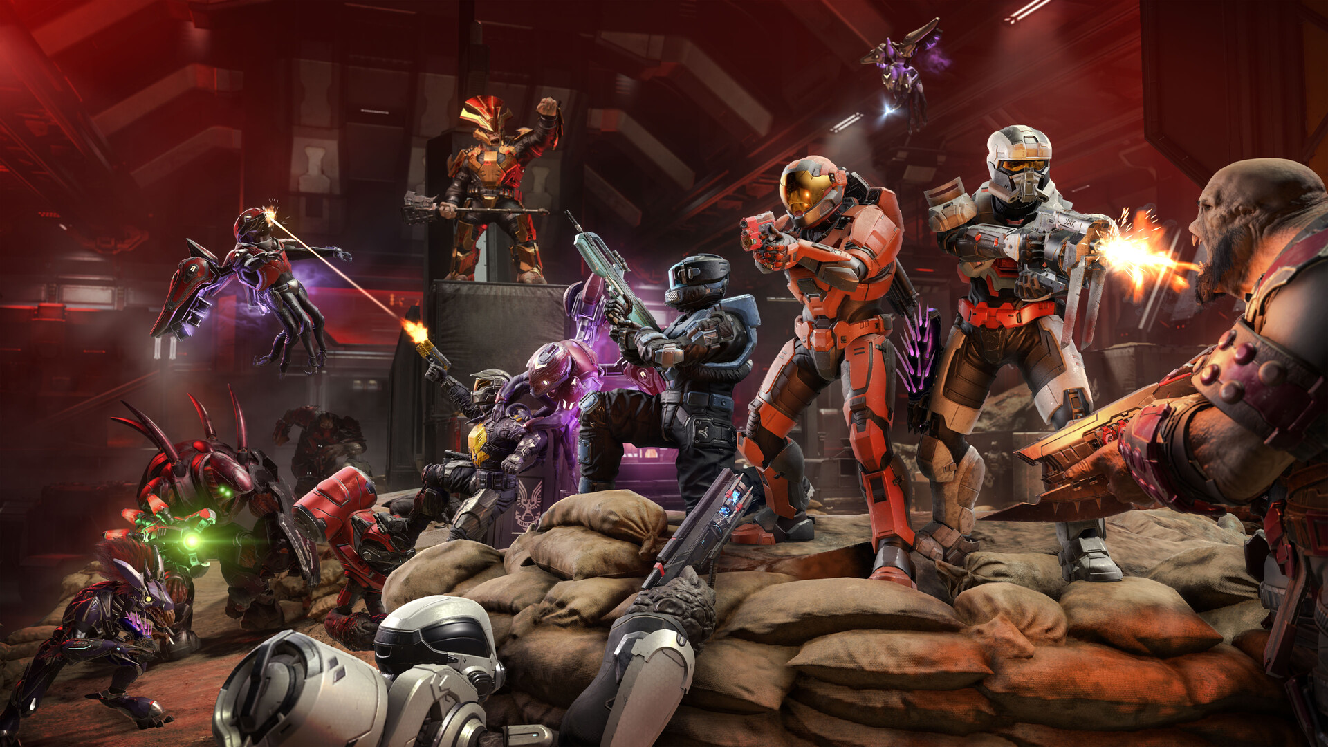Halo Infinite : un groupe de Spartans combat depuis une barricade de sacs dans une salle éclairée de rouge.
