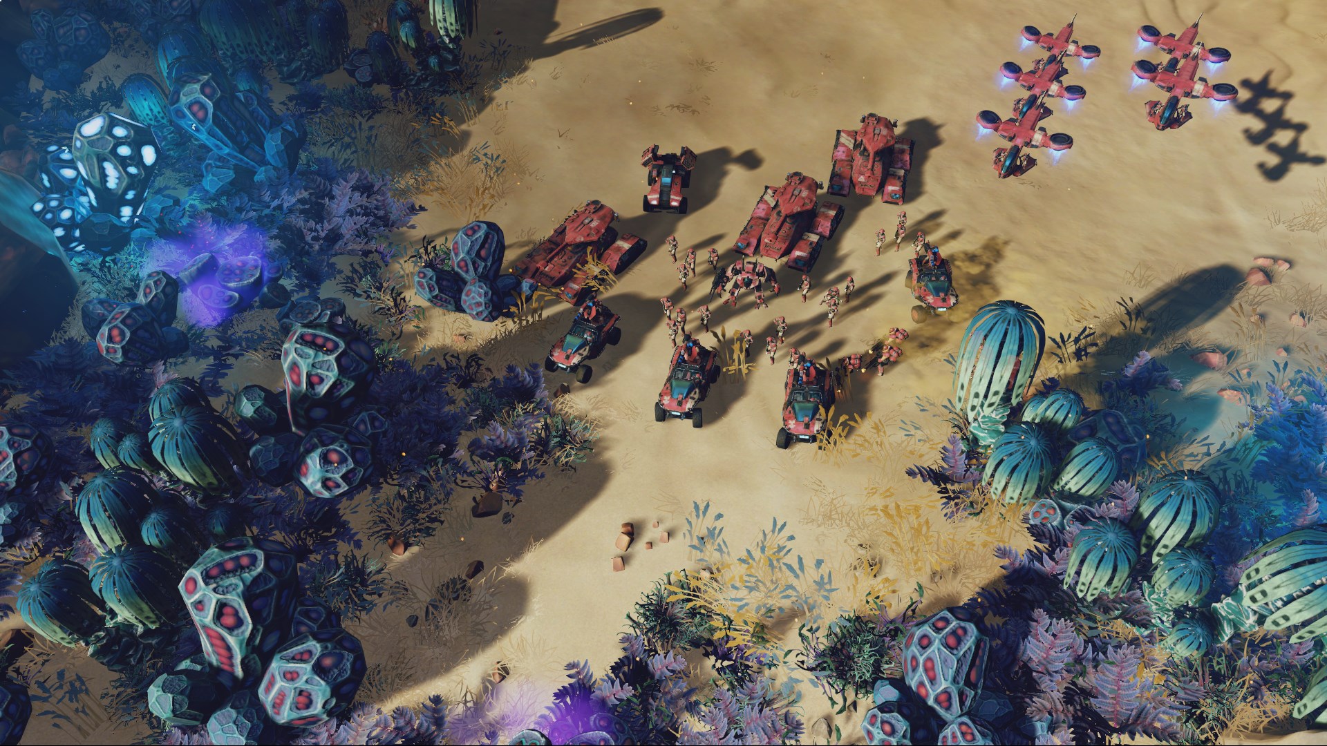 Une armée des Parias rassemble véhicules rouges et unités aériennes dans un canyon.