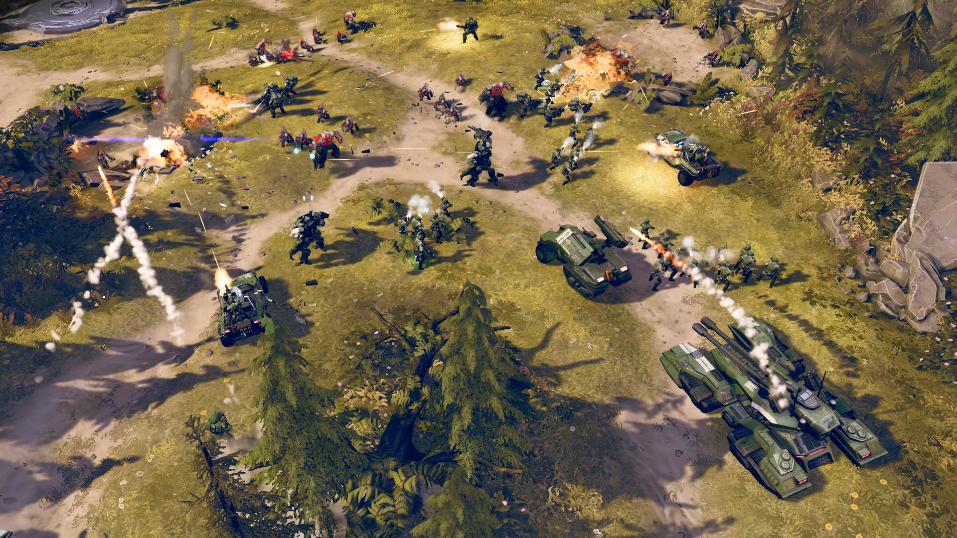 Vue d’ensemble d’un champ de bataille avec chars, troupes et explosions autour d’une base de l’UNSC.