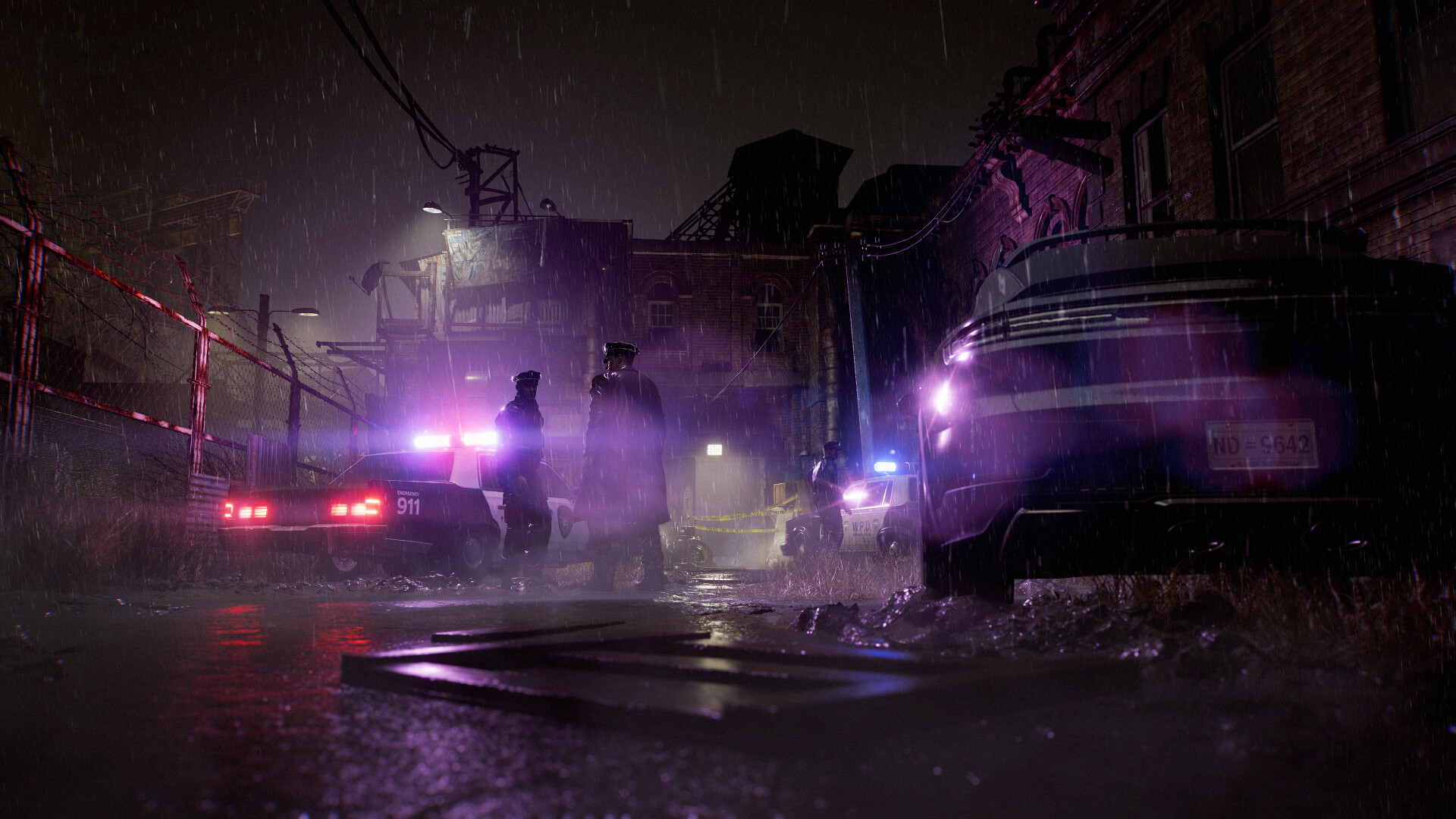 Des véhicules d’intervention éclairent une rue nocturne.