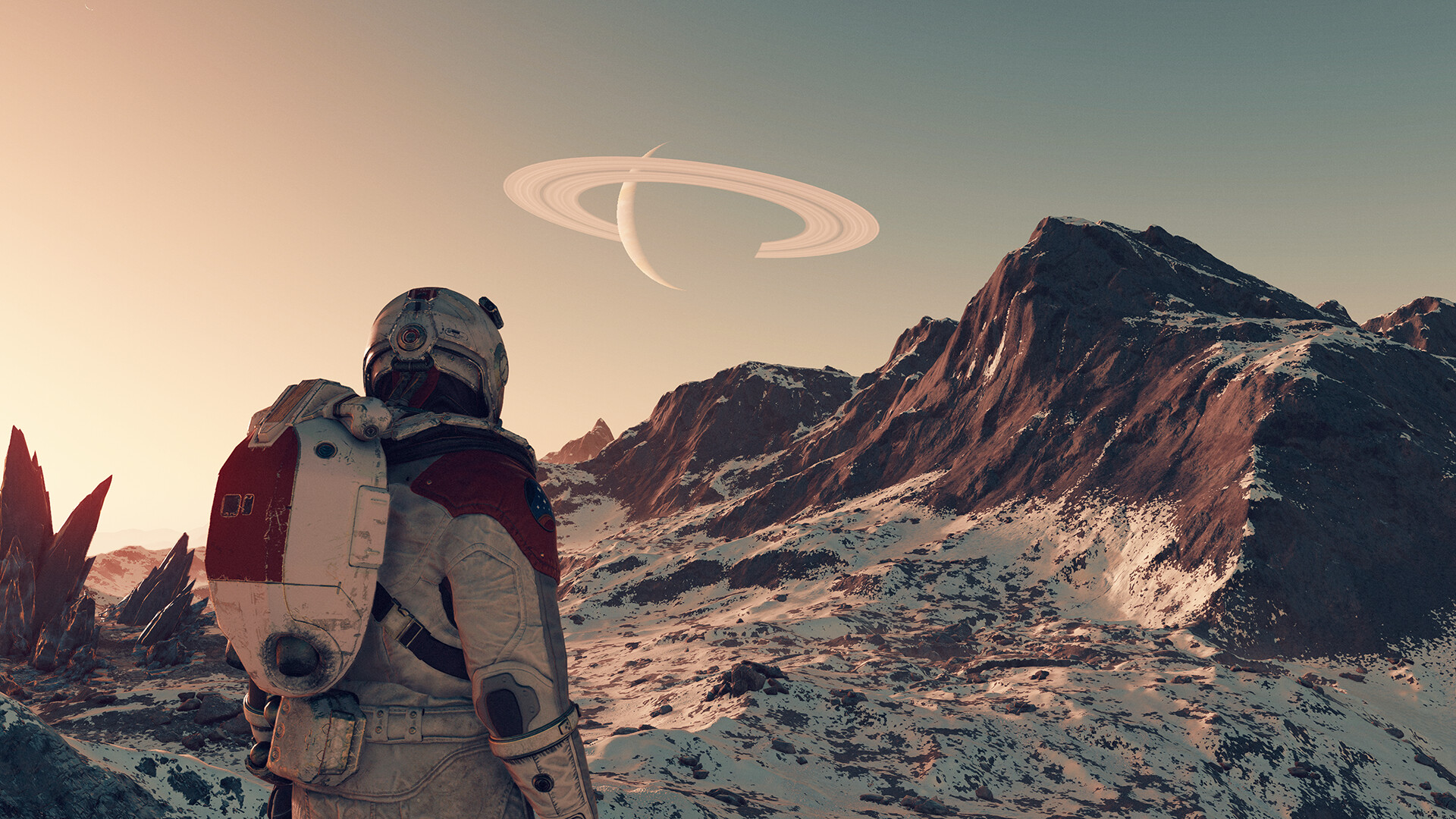 Un astronaute explore un paysage rocheux sous une planète à anneaux.