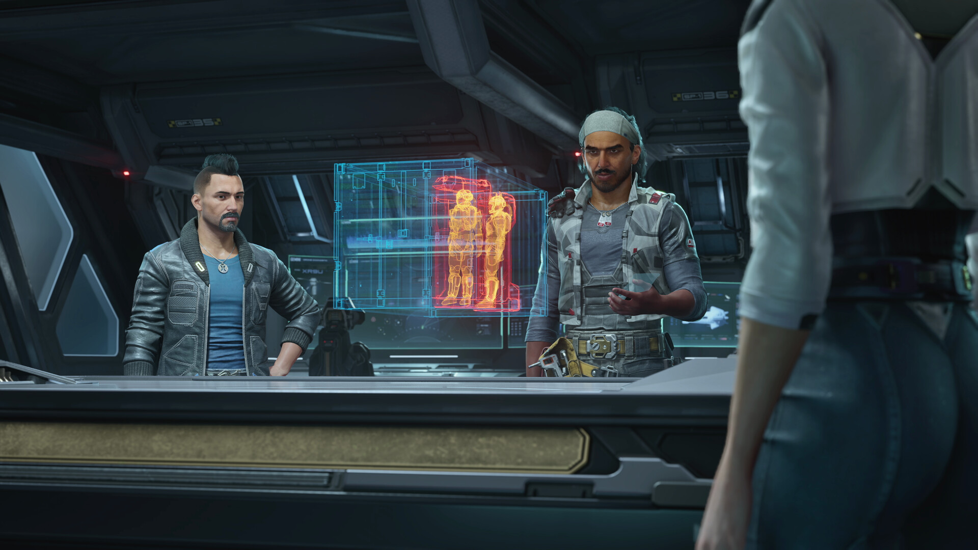 Des personnages échangent devant un écran technique.