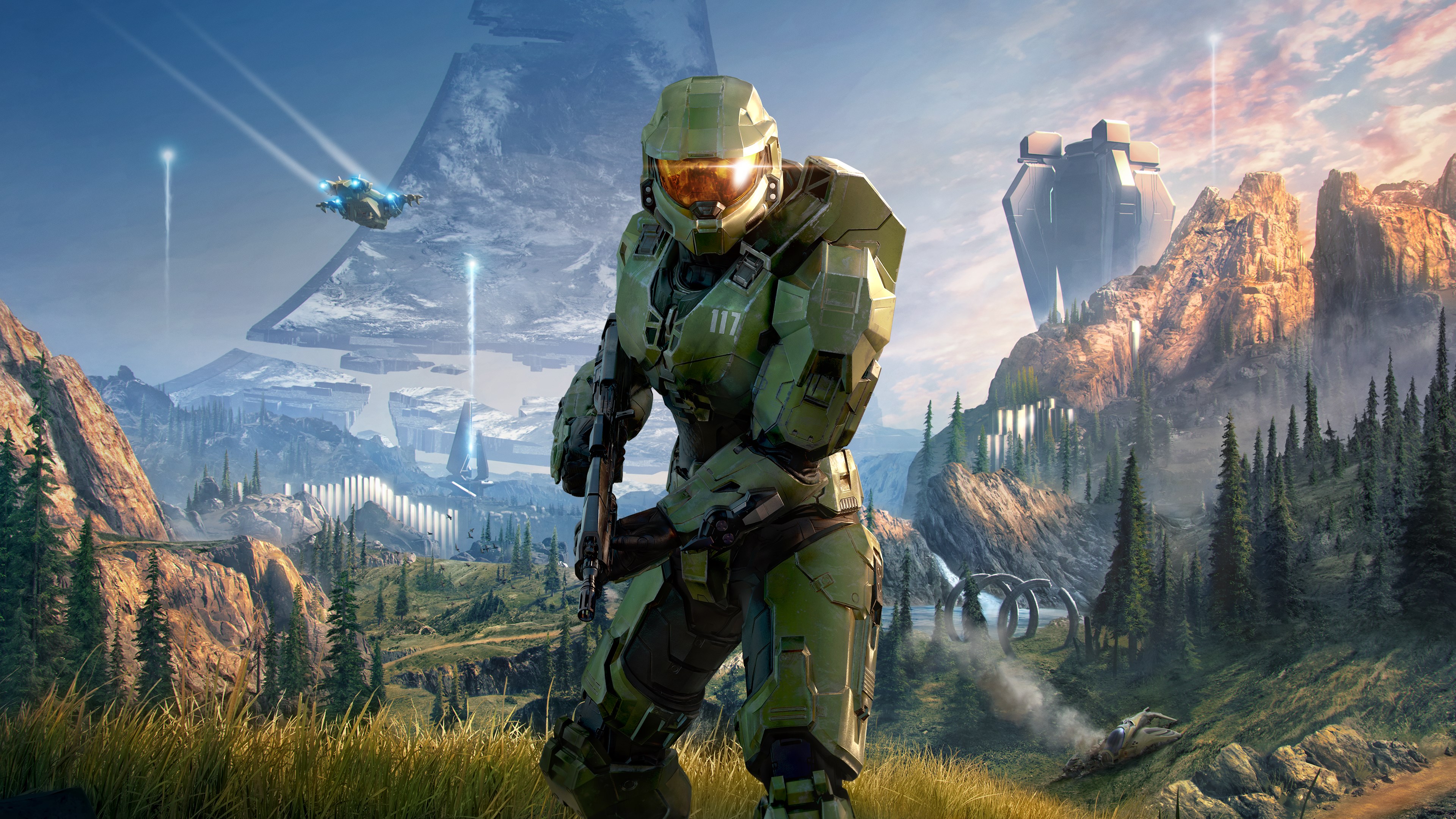 Illustration officielle de Halo Infinite : le Major dans une vallée de Zeta Halo, avec forêts, montagnes et anneau à l’horizon.