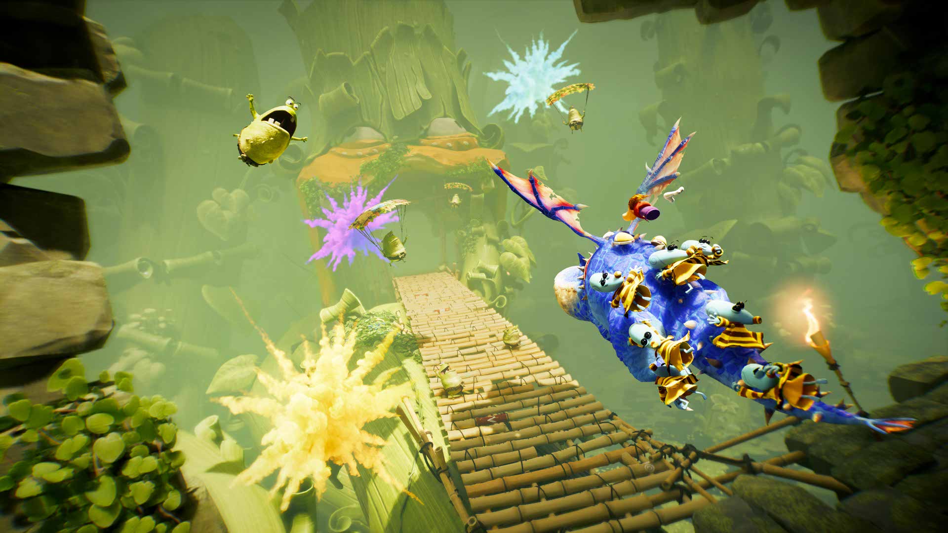 Rayman en vol au-dessus d’un dragon bleu chargé de personnages, dans un décor de ponts et de falaises.